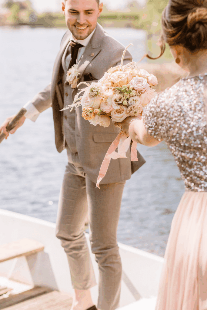 Bruidegom met zachtroze bruidsboeket – stijlvolle bruiloft waarin sfeer en budget in balans zijn