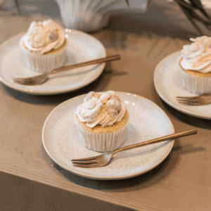 Beige dessertbordjes met gebak voor bruiloft sweet table