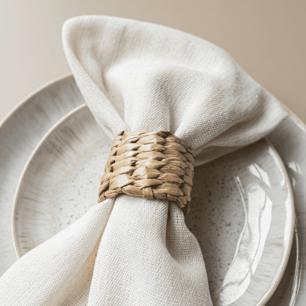 Beige bord met servet en rotan servetring Beige bord met servet en rotan servetring voor natuurlijke bruiloft tafel